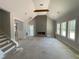 Bright and airy living room featuring a vaulted ceiling, wood beam, and a striking fireplace at 1698 Cunningham Sw Rd, Marietta, GA 30008