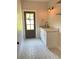 Functional mud room with stylish tile flooring, sink, and door to the exterior at 1698 Cunningham Sw Rd, Marietta, GA 30008