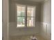 Office with white wainscoting and a view of the front porch framed by large windows at 1698 Cunningham Sw Rd, Marietta, GA 30008