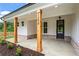 Inviting front porch with stained wood columns and craftsman-style door at 1698 Cunningham Sw Rd, Marietta, GA 30008