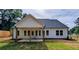 Exterior back view of home with a covered patio and a spacious backyard at 1698 Cunningham Sw Rd, Marietta, GA 30008