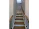 Staircase with white risers, wood treads and handrail plus black metal balusters at 1698 Cunningham Sw Rd, Marietta, GA 30008