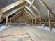 Unfinished attic space showing framing, insulation, and utilities at 1698 Cunningham Sw Rd, Marietta, GA 30008
