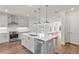 Modern kitchen with stainless appliances, white cabinets, and quartz island at 2350 Edgar Park Pl # 98, Duluth, GA 30096