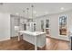 Bright, modern kitchen features a large island, stainless steel appliances, and access to the outdoor deck at 2350 Edgar Park Pl # 98, Duluth, GA 30096