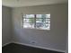 Bedroom with a large window offering natural light, neutral walls, and modern flooring at 3531 Creighton Sw Rd, Atlanta, GA 30331