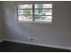 Bedroom featuring ample light from the large window, neutral walls, and modern flooring at 3531 Creighton Sw Rd, Atlanta, GA 30331