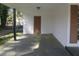 Side view of the covered carport with a side door and a white brick wall with brown shutters at 3531 Creighton Sw Rd, Atlanta, GA 30331