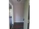 A view of the entry way features grey walls and dark wood floors through an open green door at 3531 Creighton Sw Rd, Atlanta, GA 30331