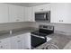 Bright kitchen with white cabinets, stainless steel appliances and granite countertops at 3531 Creighton Sw Rd, Atlanta, GA 30331