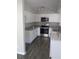 Bright kitchen with white cabinets, stainless steel appliances and granite countertops at 3531 Creighton Sw Rd, Atlanta, GA 30331