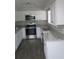 Bright kitchen with white cabinets, stainless steel appliances and granite countertops at 3531 Creighton Sw Rd, Atlanta, GA 30331