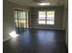 Open living room with tile flooring, sliding glass door and view to the back yard at 3531 Creighton Sw Rd, Atlanta, GA 30331