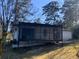 An exterior side view showing a charming screened porch and yard at 3531 Creighton Sw Rd, Atlanta, GA 30331