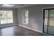 An airy sun room with grey walls, laminate flooring, large windows, and sliding door to the exterior at 3531 Creighton Sw Rd, Atlanta, GA 30331