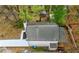 An aerial view of the backyard and the house with light gray shingle roof at 6446 E Windsor Ln, Norcross, GA 30093