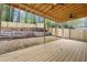 Covered back porch and backyard featuring a new wooden fence, landscaping and stone steps at 6446 E Windsor Ln, Norcross, GA 30093
