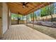 Spacious wooden deck overlooking the newly fenced backyard with stone retaining wall at 6446 E Windsor Ln, Norcross, GA 30093