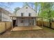 Exterior view showcasing the back deck, rear exterior, and the fenced yard at 6446 E Windsor Ln, Norcross, GA 30093