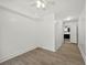 Finished basement area features hardwood floors, ceiling fan, and a glimpse into the kitchen at 6446 E Windsor Ln, Norcross, GA 30093