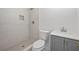 Modern bathroom featuring a tile shower, neutral color palette, and stylish vanity at 6446 E Windsor Ln, Norcross, GA 30093