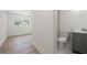 Open view of bedroom and bathroom with modern vanity, natural light, and hardwood floors at 6446 E Windsor Ln, Norcross, GA 30093