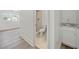 Bathroom featuring neutral tones, standing shower, and a view of a sunlit bedroom at 6446 E Windsor Ln, Norcross, GA 30093