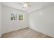 Finished room features a ceiling fan, hardwood floors and natural lighting from large windows at 6446 E Windsor Ln, Norcross, GA 30093