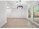 Bright dining area features luxury vinyl plank flooring and access to backyard deck at 6446 E Windsor Ln, Norcross, GA 30093
