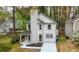Rear exterior showcasing the back of the home with a covered porch and private backyard at 6446 E Windsor Ln, Norcross, GA 30093