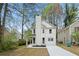 Beautiful two story house with new driveway, manicured front yard and freshly painted white exterior at 6446 E Windsor Ln, Norcross, GA 30093
