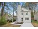 Charming two-story home with white siding, a brick chimney, and a well-manicured lawn in a suburban setting at 6446 E Windsor Ln, Norcross, GA 30093