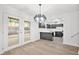 Open kitchen with modern light fixture, sleek black cabinets, stainless steel appliances, and access to the backyard at 6446 E Windsor Ln, Norcross, GA 30093