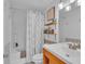 Bright bathroom featuring a shower-tub combo and built-in shelving at 1506 Knights Trl, Stone Mountain, GA 30083