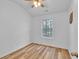Bedroom featuring a ceiling fan, a window for natural light, and wood grain laminate flooring at 1506 Knights Trl, Stone Mountain, GA 30083