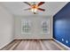 Bedroom with wood floors and a blue accent wall at 1506 Knights Trl, Stone Mountain, GA 30083