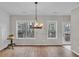 Bright dining area with wood floors, hanging light fixture and view of wooded area at 1506 Knights Trl, Stone Mountain, GA 30083