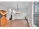 Spacious dining room with wood floors, staircase view and stylish decor at 1506 Knights Trl, Stone Mountain, GA 30083