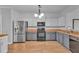 Well-lit kitchen featuring stainless steel appliances, two-toned cabinets and a hardwood floor at 1506 Knights Trl, Stone Mountain, GA 30083