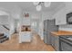 Open-concept kitchen view into the living area and staircase with modern appliances at 1506 Knights Trl, Stone Mountain, GA 30083