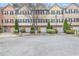 View of the townhomes showing multiple units with individual garages and neatly maintained landscaping at 1506 Knights Trl, Stone Mountain, GA 30083