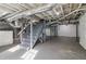 Unfinished basement with visible ductwork, pipes, gray stairs and concrete floors at 1563 Mayflower Sw Ave, Atlanta, GA 30311