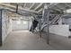 Unfinished basement with exposed ducts and pipes, painted brick walls and concrete floor at 1563 Mayflower Sw Ave, Atlanta, GA 30311