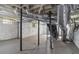 Unfinished basement with exposed ducts and pipes, painted brick walls and concrete floor at 1563 Mayflower Sw Ave, Atlanta, GA 30311