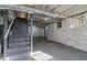 Unfinished basement with visible ductwork, pipes, gray stairs and concrete floors at 1563 Mayflower Sw Ave, Atlanta, GA 30311