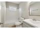 Bathroom featuring a combined tub and shower, tile walls, a vanity with sink, and a mirror at 1563 Mayflower Sw Ave, Atlanta, GA 30311
