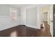 Bedroom with hardwood floors, light walls, and a doorway to an adjacent room at 1563 Mayflower Sw Ave, Atlanta, GA 30311