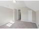 Carpeted attic bedroom with fresh paint, and an adjacent room visible through an open door at 1563 Mayflower Sw Ave, Atlanta, GA 30311