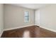 Bedroom with hardwood floors, neutral walls, and a window providing natural light at 1563 Mayflower Sw Ave, Atlanta, GA 30311