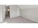 An empty bedroom with gray walls and carpet, with a door and closet at 1563 Mayflower Sw Ave, Atlanta, GA 30311